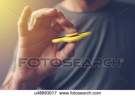 Man playing with fidget spinner. View Large Photo Image Stock Photo - Man playing with fidget spinner.. Fotosearch