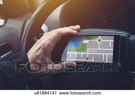 Stock Photo - Man using GPS navigation on mobile phone.. Fotosearch