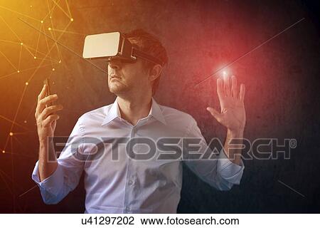 Man with VR headset exploring virtual reality. View Large Photo Image Stock Image - Man with VR headset exploring virtual reality.. Fotosearch