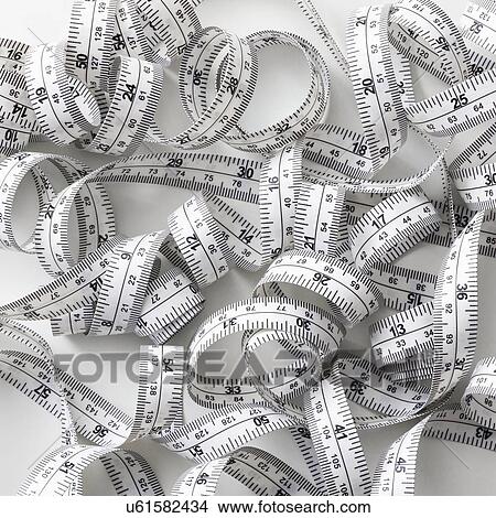 Measuring tape against a white background. View Large Photo Image Picture - Measuring tape against a white background.. Fotosearch