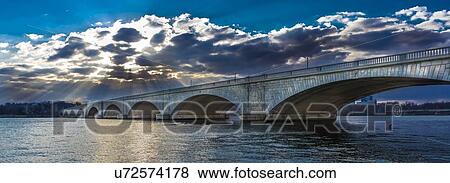 Stock Photo - Memorial Bridge at dusk spans Potomac River at sunset . Fotosearch