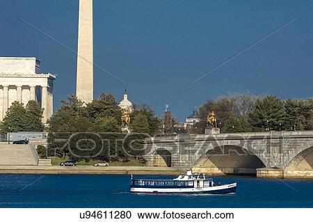 Memorial Bridge spans Potomac River and features Lincoln Memorial and Washington Monument with tour boat in lower frame at sunset View Large Photo Image Stock Image - Memorial Bridge spans Potomac River and features Lincoln Memorial and Washington Monument with tour boat in lower frame at sunset. Fotosearch