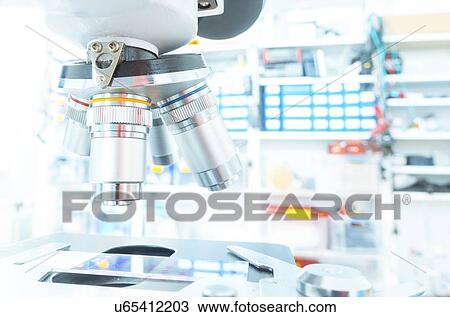 Stock Image - Microscope stage and lenses.. Fotosearch