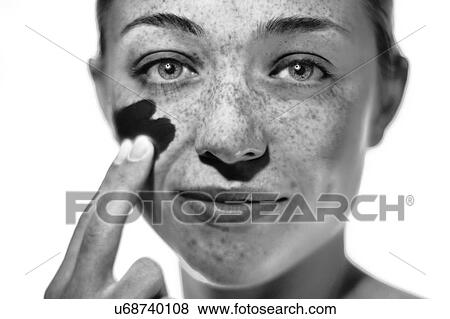 MODEL RELEASED. Woman applying sunscreen to her cheek. View Large Photo Image Stock Photo - MODEL RELEASED. Woman applying sunscreen to her cheek.. Fotosearch