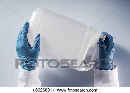 Stock Photo - Opening container of hazardous substance.. Fotosearch