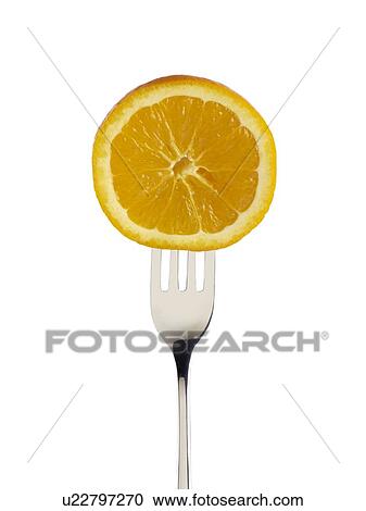 Stock Image - Orange cut in half on a fork.. Fotosearch