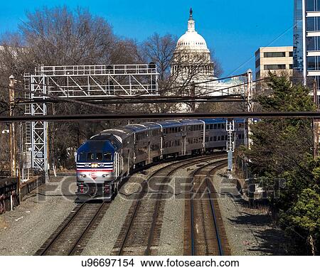 Picture - Passenger train with US Capitol in background approaches L'enfant Plaza Station, Washington D. C.. Fotosearch