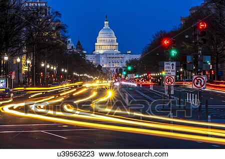 Stock Image - Pennsylvania Ave to US Capitol with streaked lights going towards US Capitol in Washington DC. during rush hour PM. Fotosearch