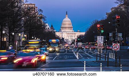 Stock Image - Pennsylvania Ave to US Capitol with streaked lights going towards US Capitol in Washington DC. during rush hour PM. Fotosearch