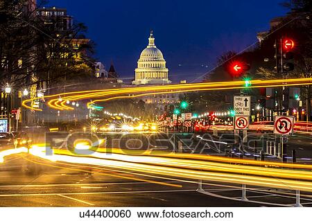 Stock Image - Pennsylvania Ave to US Capitol with streaked lights going towards US Capitol in Washington DC. during rush hour PM. Fotosearch