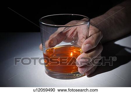 Person holding a glass of whisky, studio shot. View Large Photo Image Stock Image - Person holding a glass of whisky, studio shot.. Fotosearch