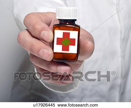 Person holding pill bottle containing medicinal marijuana. View Large Photo Image Stock Photography - Person holding pill bottle containing medicinal marijuana.. Fotosearch