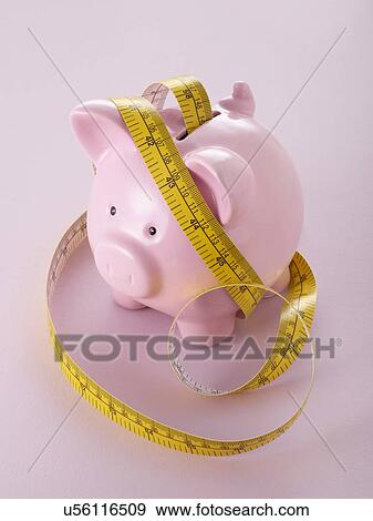 Piggy bank and tape measure. View Large Photo Image Stock Photo - Piggy bank and tape measure.. Fotosearch