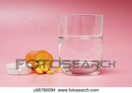 Pills and glass of water. View Large Photo Image Picture - Pills and glass of water.. Fotosearch