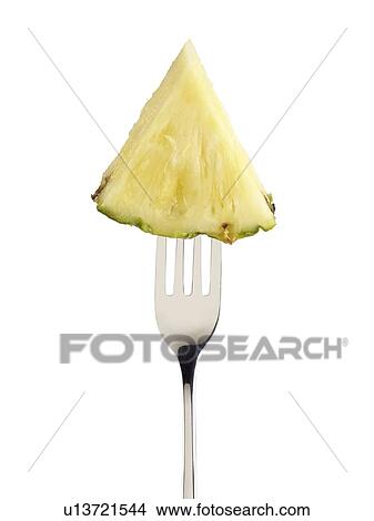 Picture - Pineapple slice on a fork.. Fotosearch