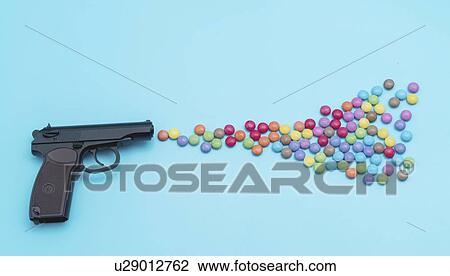 Stock Image - Pistol shooting sweets.. Fotosearch