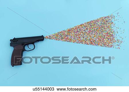 Stock Image - Pistol shooting sweets.. Fotosearch