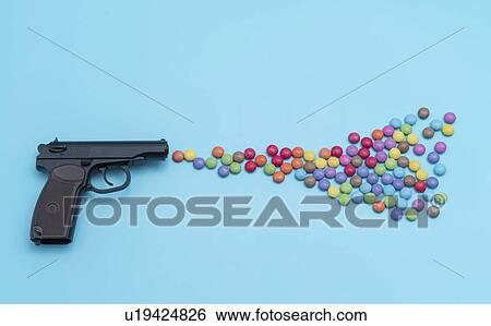 Stock Photograph - Pistol shooting sweets.. Fotosearch
