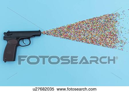 Stock Photography - Pistol shooting sweets.. Fotosearch