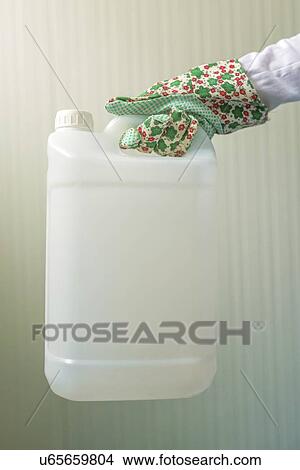 Picture - Plastic canister in female hand.. Fotosearch