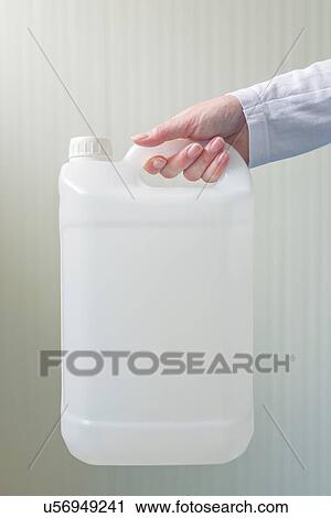 Stock Image - Plastic canister in female hand.. Fotosearch