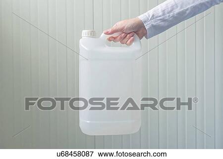 Stock Photo - Plastic canister in female hand.. Fotosearch