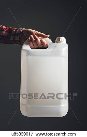 Plastic canister in female hand. View Large Photo Image Stock Photo - Plastic canister in female hand.. Fotosearch