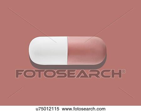 Stock Photography - Red and white capsule, studio shot.. Fotosearch