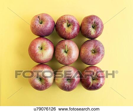 Stock Photograph - Red apples on yellow background.. Fotosearch