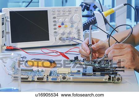 Picture - Repairing printed circuit board.. Fotosearch