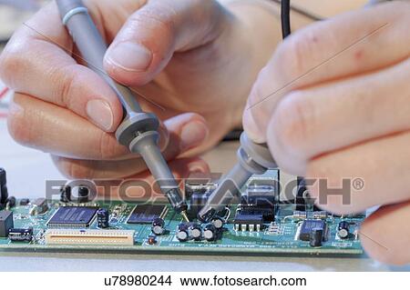 Picture - Repairing printed circuit board.. Fotosearch