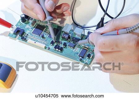 Stock Photography - Repairing printed circuit board.. Fotosearch