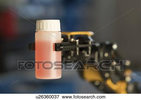 Robotic arm holding bottle. View Large Photo Image Stock Photo - Robotic arm holding bottle.. Fotosearch