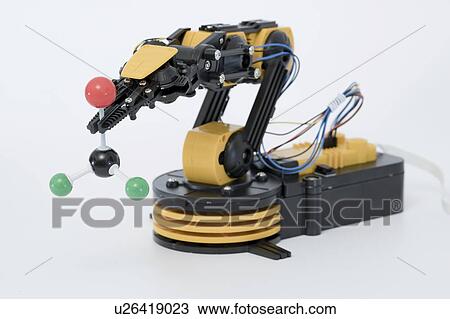 Stock Image - Robotic arm holding molecular model.. Fotosearch