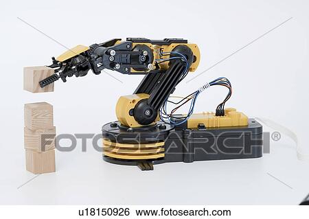 Stock Photograph - Robotic arm using building blocks.. Fotosearch