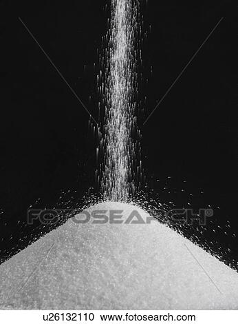 Stock Image - Salt pouring into a pile.. Fotosearch