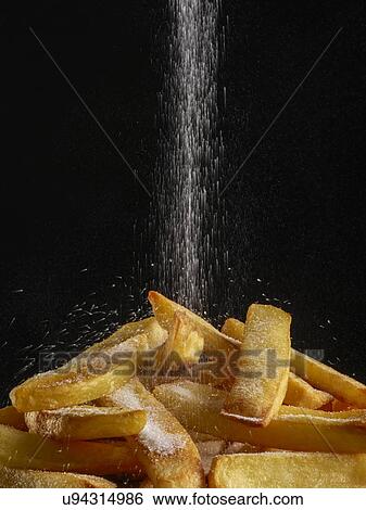 Salt pouring onto chips. View Large Photo Image Stock Photograph - Salt pouring onto chips.. Fotosearch