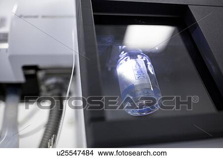 Picture - Sample for analysis by liquid chromatography in an autosampler machine. This machine delivers samples to the liquid chromatography machine. Liquid chromatography is used to separate compounds from a mixture of compounds dissolved in a liquid.. Fotosearch