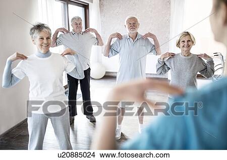 Picture - Senior adults doing exercise class.. Fotosearch