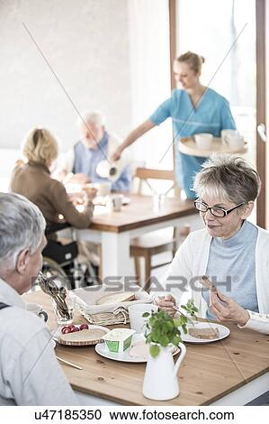 Senior adults eating meal in care home. View Large Photo Image Stock Image - Senior adults eating meal in care home.. Fotosearch