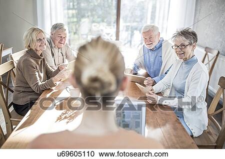 Stock Image - Senior adults in care home with digital tablets.. Fotosearch