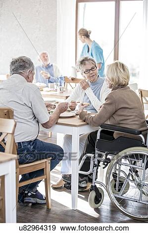 Senior adults in care home, woman in wheelchair. View Large Photo Image Stock Photo - Senior adults in care home, woman in wheelchair.. Fotosearch
