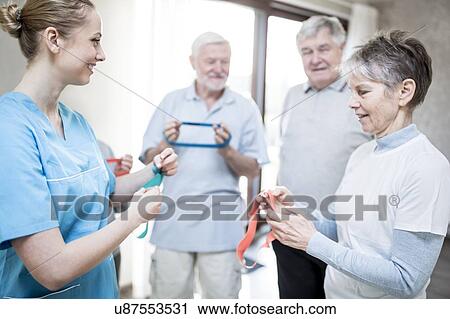 Senior adults with physiotherapist in exercise class. View Large Photo Image Stock Image - Senior adults with physiotherapist in exercise class.. Fotosearch