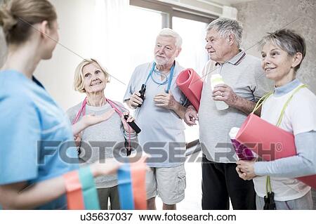 Stock Photo - Senior adults with physiotherapist in exercise class.. Fotosearch