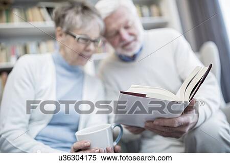 Stock Photography - Senior couple reading book.. Fotosearch