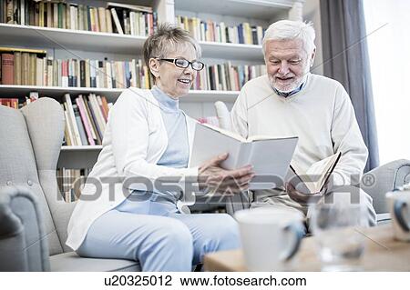 Stock Image - Senior couple reading books.. Fotosearch