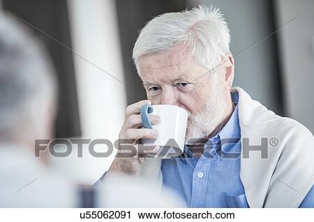 Stock Image - Senior man drinking mug of tea.. Fotosearch