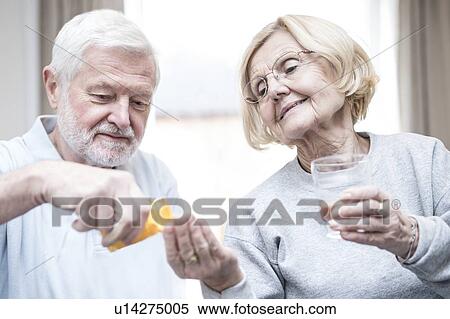 Senior man giving woman medication. View Large Photo Image Stock Photography - Senior man giving woman medication.. Fotosearch