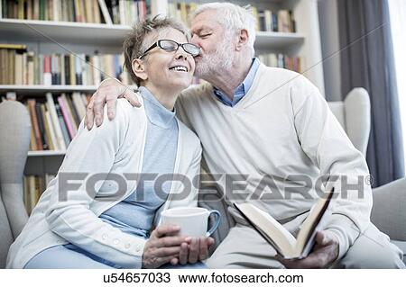 Senior man kissing woman on cheek with arm around her. View Large Photo Image Stock Image - Senior man kissing woman on cheek with arm around her.. Fotosearch