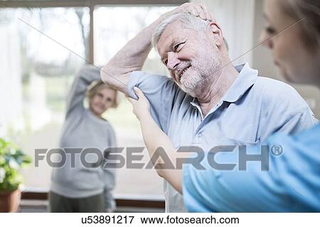 Senior man stretching, physiotherapist helping. View Large Photo Image Stock Photo - Senior man stretching, physiotherapist helping.. Fotosearch